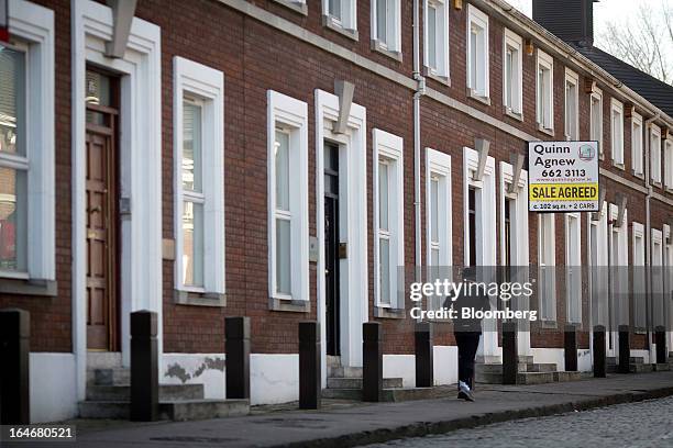 An estate agents sign reads 'Sale Agreed' outside residential properties near to Grand Canal Dock in Dublin, Ireland, on Saturday, March 16, 2013....