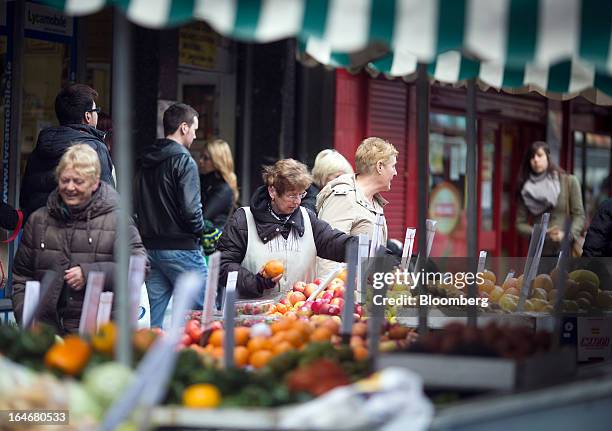 Market trader arranges her fruit and vegetable display on a stall in Moore Street in Dublin, Ireland, on Saturday, March 16, 2013. Ireland’s renewed...