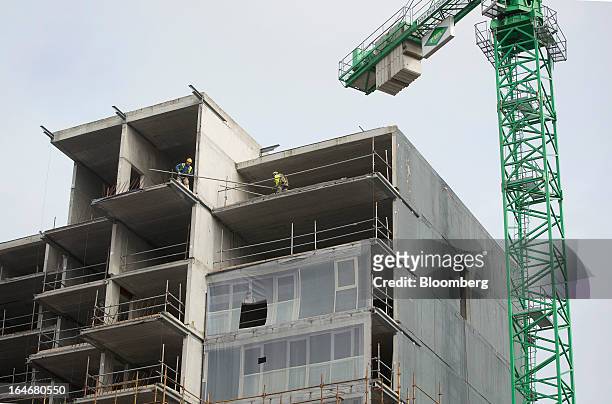 Builders are seen working on a block of residential apartments under construction at Beacon South Quarter in the area of Sandyford, in Dublin,...