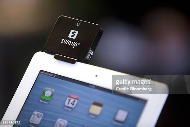 Credit and debit card reader manufactured by SumUp Ltd., specialists in mobile transactions, sits on an Apple Inc. IPad inside the company's...