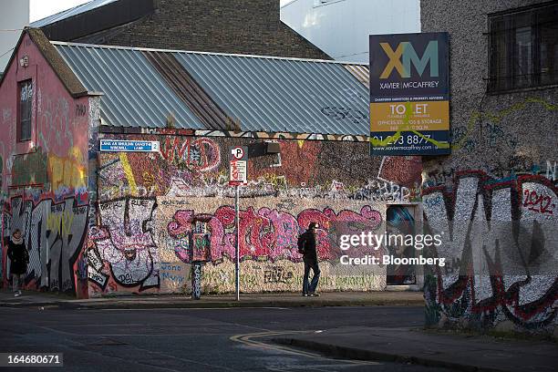 Sign advertising commercial property 'To Let' sits above graffiti covered buildings along Creighton Street, in Dublin, Ireland, on Thursday, March...