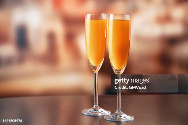 mimosa cocktail in a flute - mimosa drink stock pictures, royalty-free photos & images
