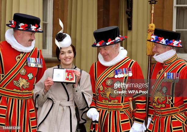 Olympic Gold Medal winning cyclist Victoria Pendleton holds her Commander of the British Empire award after the Investiture Ceremony with Yeomen of...