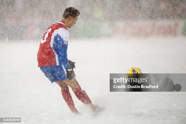 Defender Giancarlo Gonzalez of Costa Rica kicks the ball out of a layer of snow during a FIFA 2014 World Cup Qualifier match against the United...