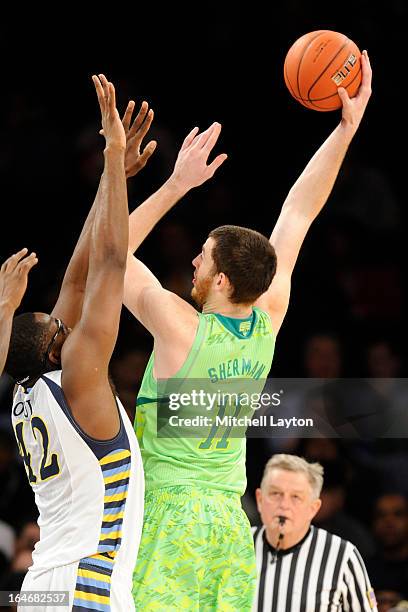 Garrick Sherman of the Notre Dame Fighting Irish takes a shot over Chris Otule of the Marquette Golden Eagles during a quarterfinal Big East...