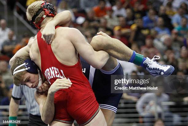 Kyle Dake of the Cornell Big Red wrestles David Taylor of the Penn State Nittany Lions in the 165-pound championship match at the 2013 NCAA Wrestling...