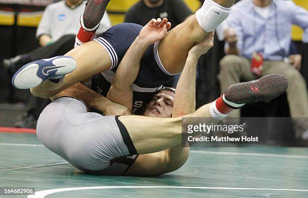 David Taylor of the Penn State Nittany Lions wrestles Peter Yates of the Virginia Tech Aggies in their 165-pound semifinal match at the 2013 NCAA...