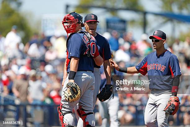 Pitcher Alfredo Aceves of the Boston Red Sox is restrained by catcher Ryan Lavarnway during a Grapefruit League Spring Training Game against the...