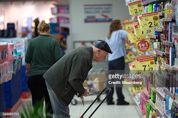 Customers browse goods for sale inside a Carrefour SA supermarket at the Mall of Cyprus in Nicosia, Cyprus, on Tuesday, March 26, 2013. Controls on...