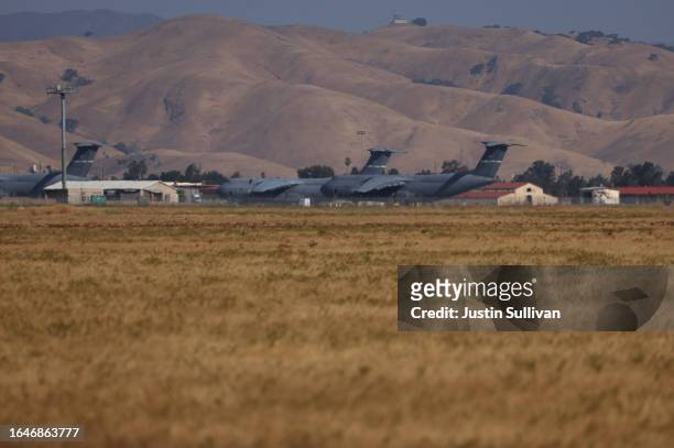 Air Force planes are seen from a parcel of land that was recently purchased next to base on August 29, 2023 near Suisun City, California. Silicon...