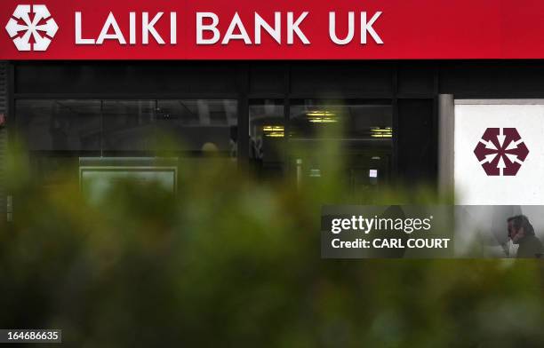 Man walks past a branch of Laiki Bank UK, a subsiduary of Cyprus Popular Bank , in north London on March 26, 2013. British Chancellor of the...