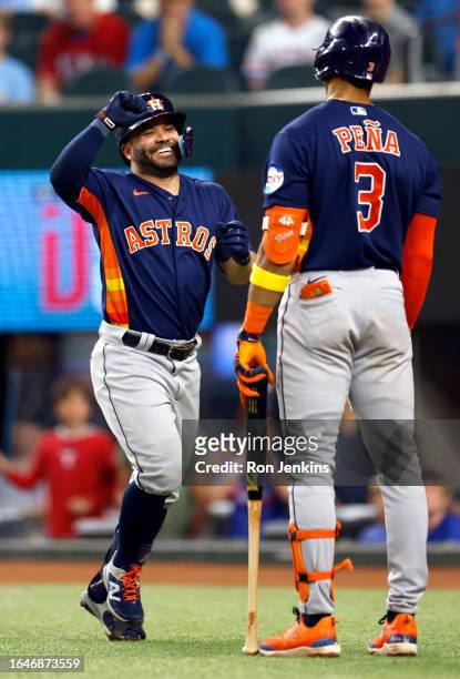 Jose Altuve of the Houston Astros celebrates with teammate Jeremy Pena after hitting a solo home run against the Texas Rangers during the third...