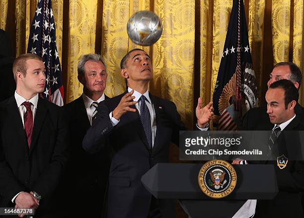 President Barack Obama bounces a soccer ball on his head while hosting a ceremony honoring players and coaches from the National Hockey League...