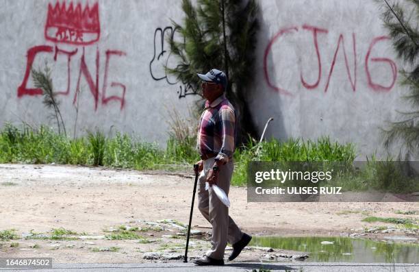 The initials of the drug cartel "Jalisco Nueva Generacion" are seen in graffiti on a wall in Lagos de Moreno, Jalisco State, Mexico, on August 29,...