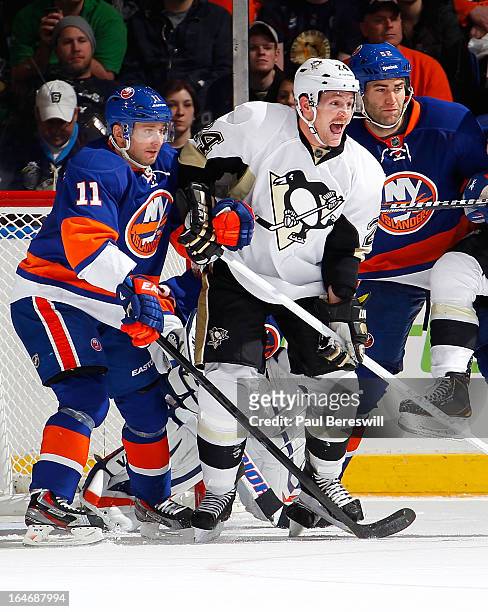 Lubomir Visnovsky and Joe Finley of the New York Islanders defend against Matt Cooke of the Pittsburgh Penguins in an NHL hockey game at Nassau...