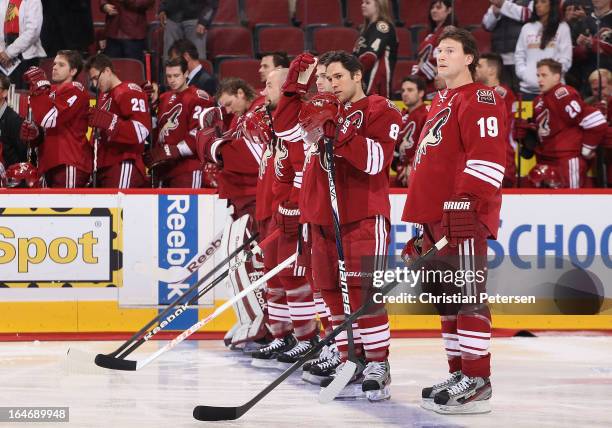 Matthew Lombardi and Shane Doan of the Phoenix Coyotes line up with teammates before the NHL game against the Minnesota Wild at Jobing.com Arena on...