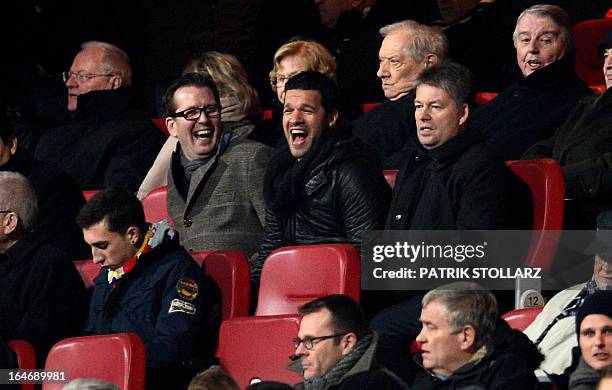 Former captain of the German national team Michael Ballack laughs as he follows the game on the tribune during the Germany vs Kazakhstan FIFA 2014...