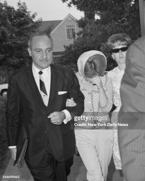 Mrs. Alice Crimmins is accompanied by her lawyer, Michael LoPenna, as she leaves police station.