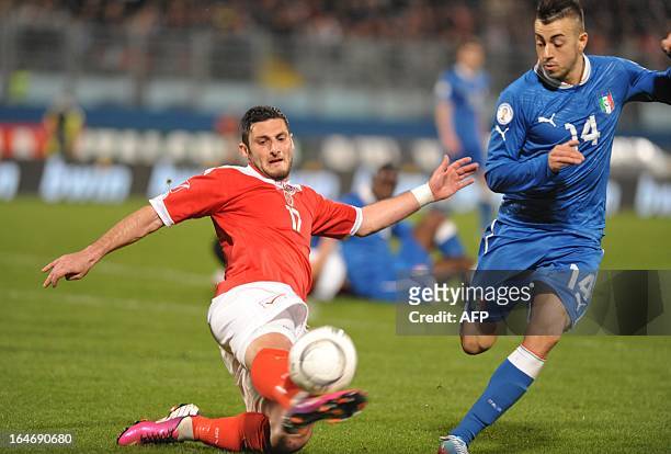 Malta's Ryan Camilleri vies with Italy's Stephan El Shaarawy during the FIFA 2014 World Cup qualifying football match Malta vs.Italy at the National...