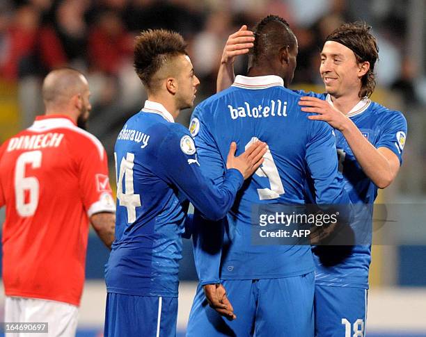 Italy's Mario Balotelli is congratulated by team mates Riccardo Montolivo and Stephen El Shaarawy during the FIFA 2014 World Cup qualifying football...