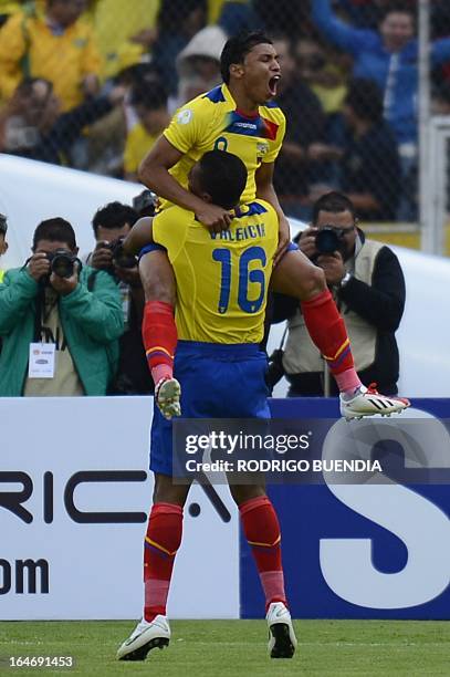 Ecuadorean Jefferson Montero celebrates with teammate Antonio Valencia, his goal against Paraguay during their FIFA World Cup Brazil 2014 South...