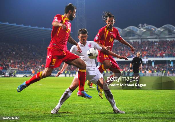 Michael Carrick of England battles with Mirko Vucinic and Dejan Damjanovic of Montenegro during the FIFA 2014 World Cup Qualifier Group H match...