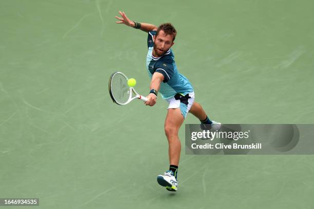 Corentin Moutet of France returns a shot against Andy Murray of Great Britain during their Men's Singles First Round match on Day Two of the 2023 US...
