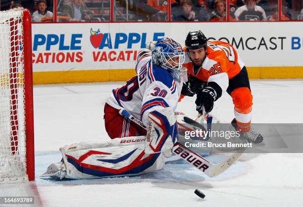 Henrik Lundqvist of the New York Rangers makes the save in the second period as Maxime Talbot of the Philadelphia Flyers looks for the rebound at the...