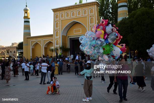 This photo taken on July 13, 2023 shows people visiting the main square in front of the Id Kah Mosque in Kashgar in China's northwestern Xinjiang...