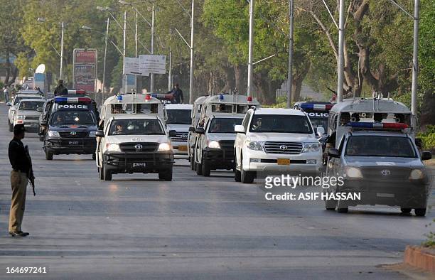 Pakistan-unrest-vote-security,FOCUS by Masroor Gilani In this photograph taken on March 24 Pakistani paramilitary and police vehicles escort a...