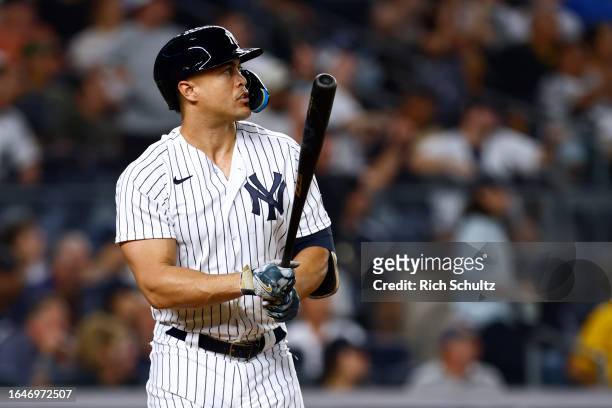 Giancarlo Stanton of the New York Yankees hits a two-run home run against the Detroit Tigers during the sixth inning of a game at Yankee Stadium on...