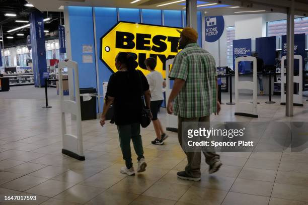 People walk into a Best Buy store in a Brooklyn mall on August 29, 2023 in New York City. Shares of the tech retail chain rose 6% to $78.50 Tuesday...