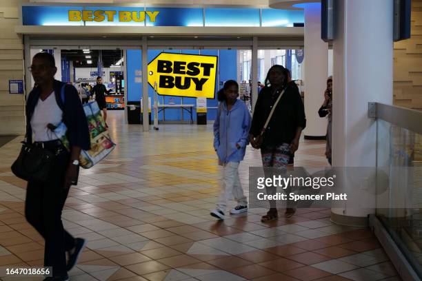 People walk by a Best Buy store in a Brooklyn mall on August 29, 2023 in New York City. Shares of the tech retail chain rose 6% to $78.50 Tuesday...