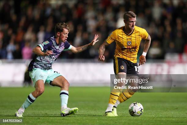 Scot Bennett of Newport County on the ball ahead of Ethan Brierley of Brentford during the Carabao Cup Second Round match between Newport County and...