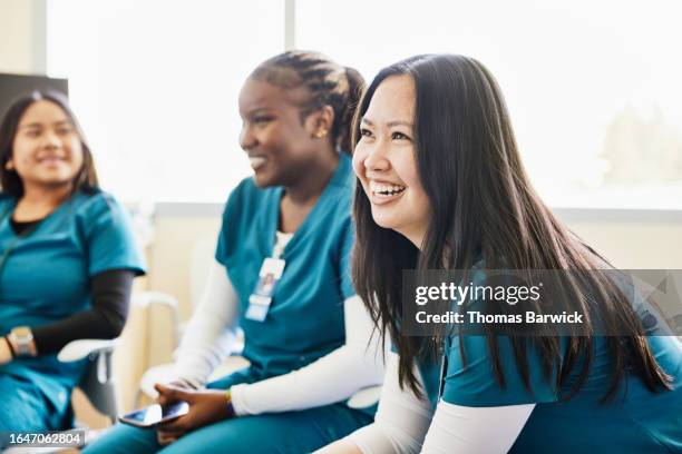 medium shot nurse in medical team meeting in hospital conference room - suivi des malades photos et images de collection