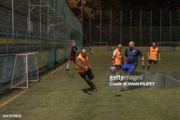 Ukrainian amputee soldiers with others attend a football training session in Kyiv, on August 31 amid the Russian invasion of Ukraine. Once or twice a...