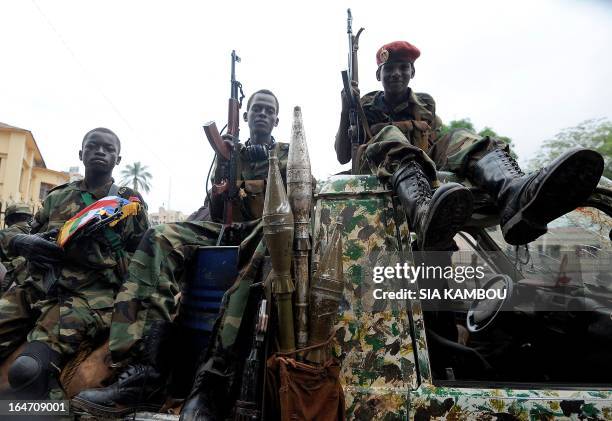 Child soldiers of the Seleka coalition sits on a pickup truck near the Presidential palace in Bangui on March 25, 2013. Seleka coalition rebels...