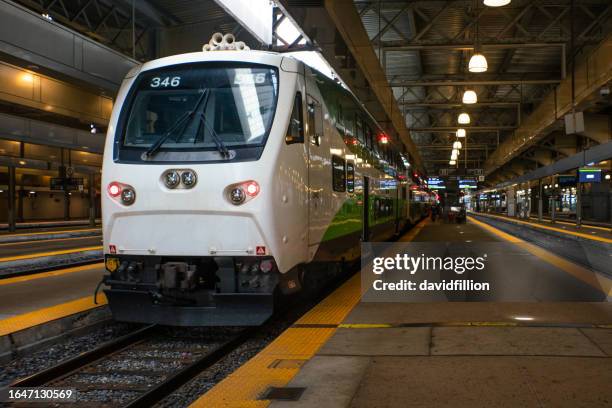 passenger train at platform with people boarding - toronto subway stock pictures, royalty-free photos & images