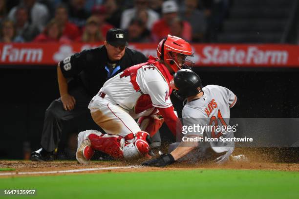 Los Angeles Angels catcher Logan O'Hoppe tags out Baltimore Orioles left fielder Austin Hays trying to score during the MLB game between the...