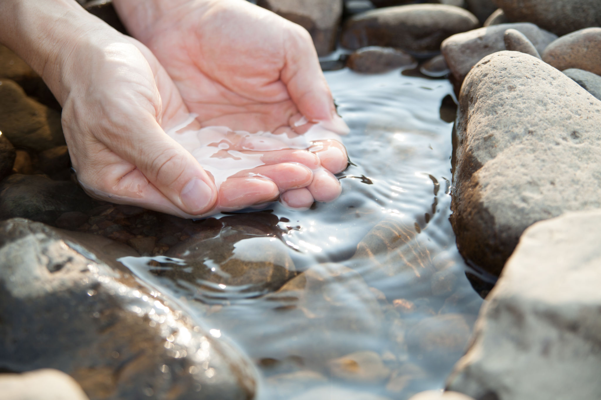 hands touching the body of water hands touching the body of water