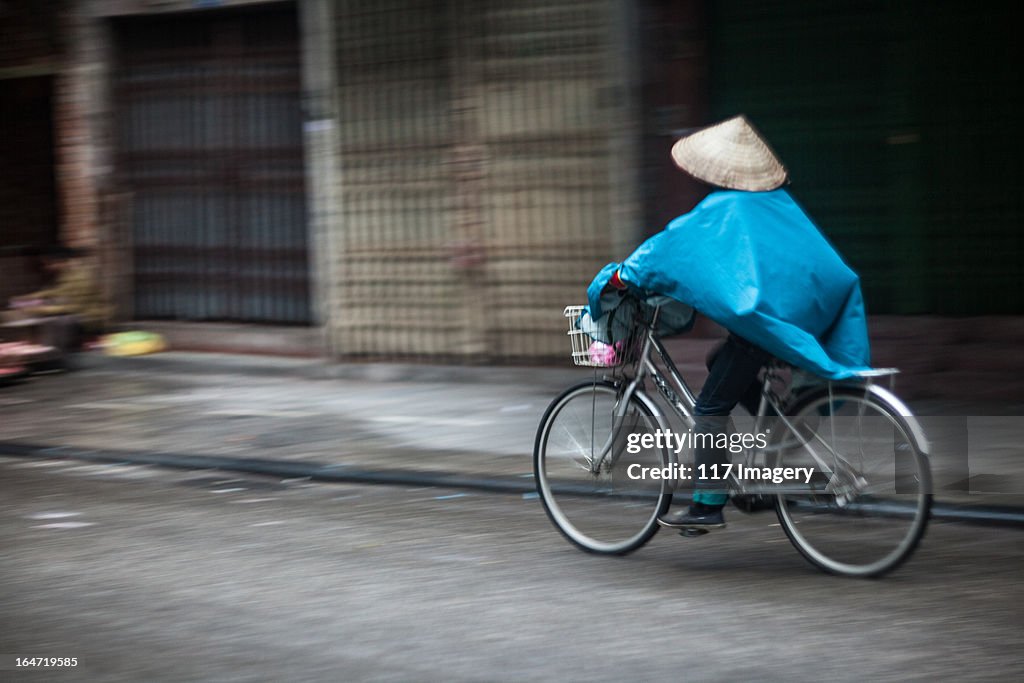 Riding a bicycle in old street, Hanoi, Vietnam