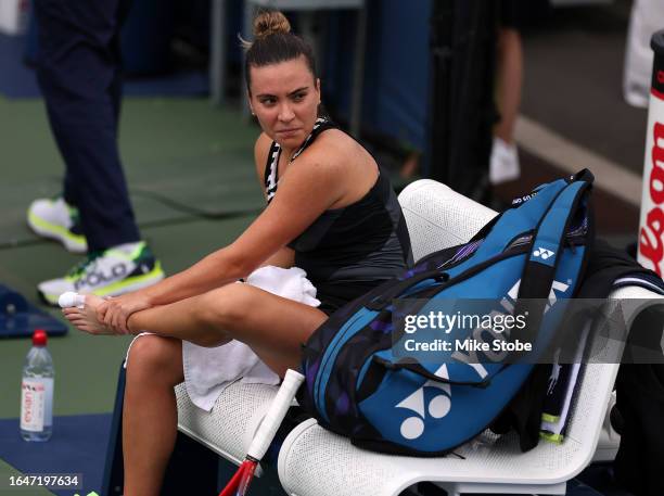Elena-Gabriela Ruse of Romania sits on the bench with her taped toe exposed against Karolina Pliskova of the Czech Republic during their Women's...