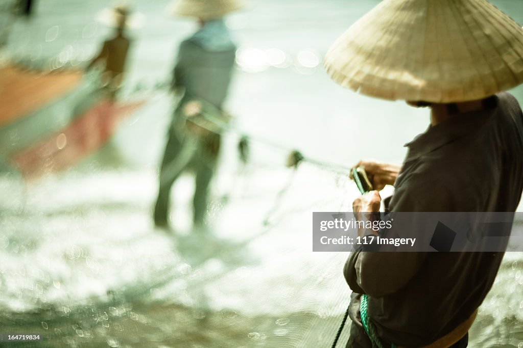 Fishermen holding fish net