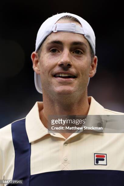 John Isner of the United States celebrates match point against Facundo Diaz Acosta of Argentina during their Men's Singles First Round match on Day...