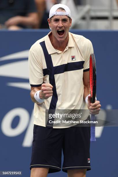 John Isner of the United States celebrates match point against Facundo Diaz Acosta of Argentina during their Men's Singles First Round match on Day...