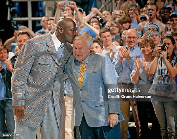 Michael Jordan kisses former coach Dean Smith of the North Carolina Tar Heels during a halftime ceremony honoring the 1993 national championship team...