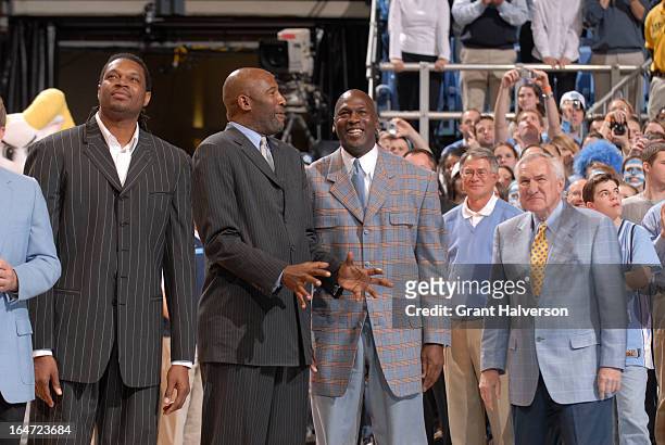Former players Sam Perkins, James Worthy and Michael Jordan and former coach Dean Smith of the North Carolina Tar Heels are honored during a halftime...