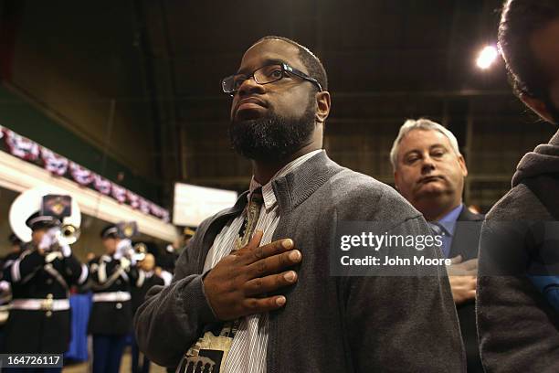 Army veteran Adrian Anderson, who served in both Iraq and Afghanistan, stands for the national anthem during the Hiring Our Heroes military job fair...