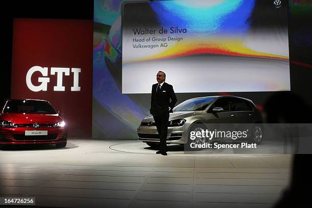 Walter de Silva, Head of Group Design at Volkswagen AG stands next to the new U.S. Version of the Volkswagen redesigned Golf and the new GTI at the...