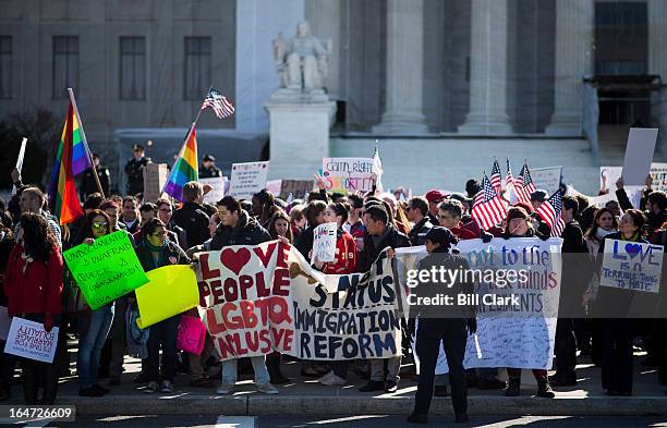 Marriage equality supporters wave flags and signs as they rally in front of the Supreme Court before oral arguments in the United States v. Windsor...